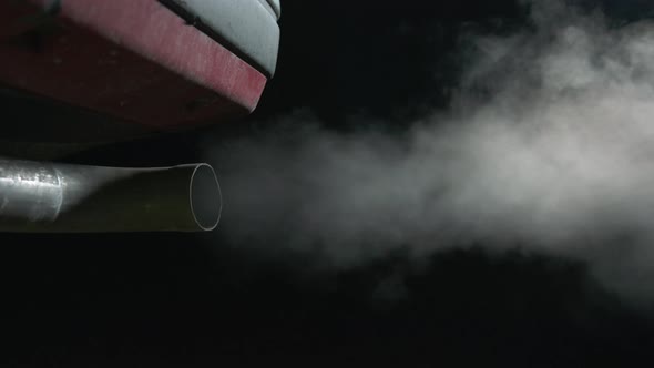 Black background, car exhaust, night. Global warming, sustainability. 60fps alt