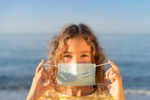 Happy child wearing medical mask outdoor - Stock Photo - Images