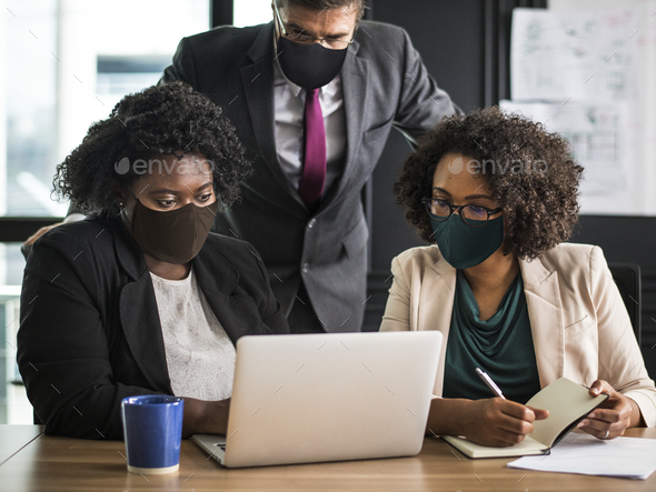 Business new normal, people wearing masks in the office