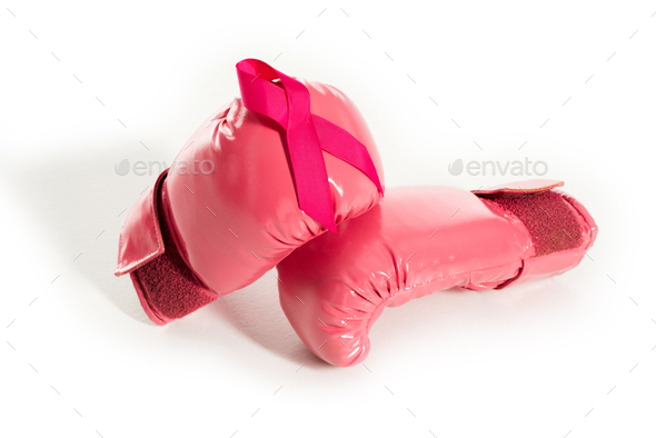 close-up view of pink boxing gloves and ribbon isolated on white, breast cancer concept