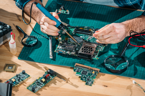 Close-up view of engineer soldering pc parts