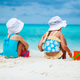 Two little happy girls have a lot of fun at tropical beach playing together  Stock Photo by travnikovstudio