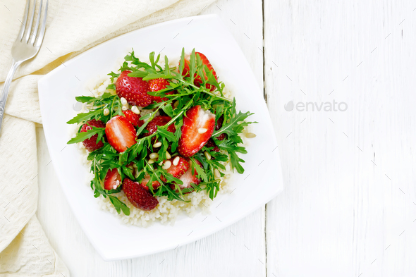 Salad of strawberry and couscous on light board top - Stock Photo - Images