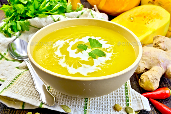 Soup-puree pumpkin with cream in bowl on napkin - Stock Photo - Images