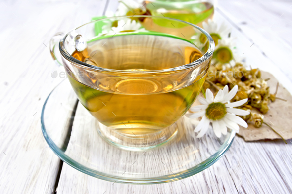 Tea chamomile in cup on light board - Stock Photo - Images