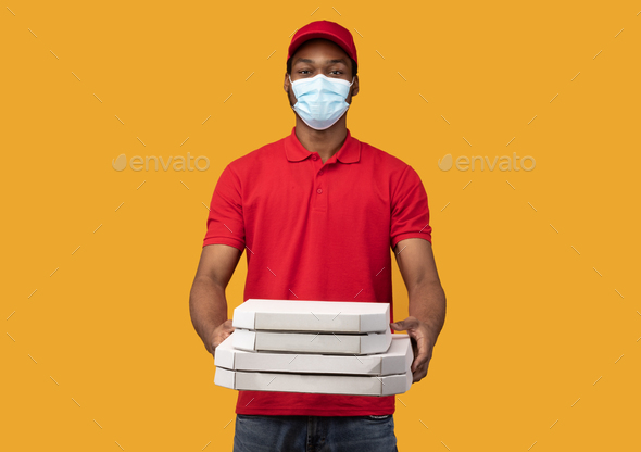 Black Delivery Man In Medical Mask Holding Pizza Boxes Stock Photo By Prostock Studio