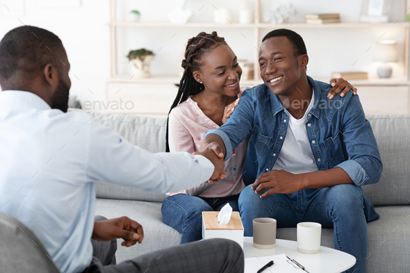 Grateful Black Spouses Shaking Hands With Counselor After Successful Marital Therapy