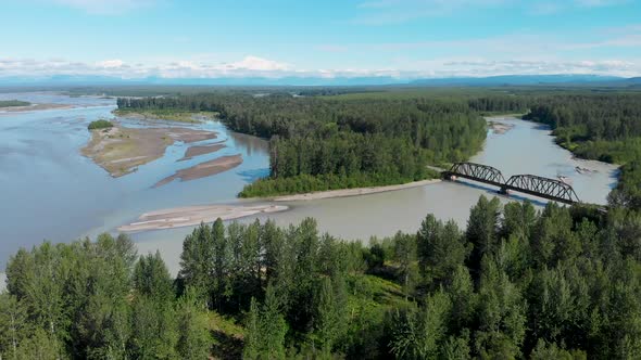 4K Drone Video of Alaska Railroad Train Trestle with Mt. Denali in Distance during Summer alt