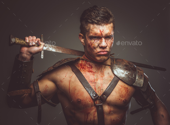 Bloody gladiator in armor. - Stock Photo - Images