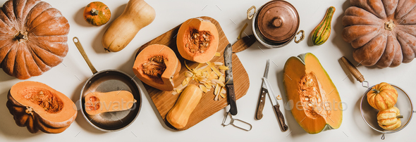 Flat-lay of cleaning and cooking pumpkin on wooden board