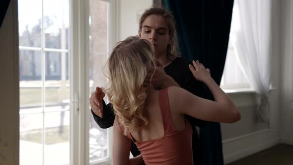 Sensual Loving Dancing Pair is Dancing in Light Room with Sunbeams alt