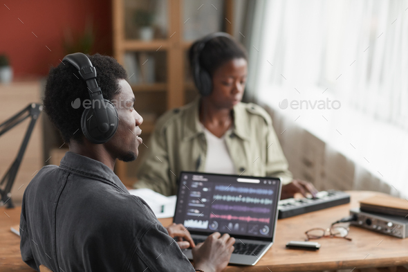 African-American Man Editing Music in Studio