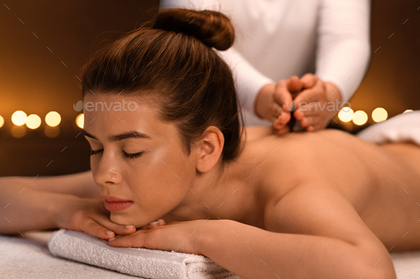 Young Beautiful Woman Getting Back Massage Stock Photo, Picture