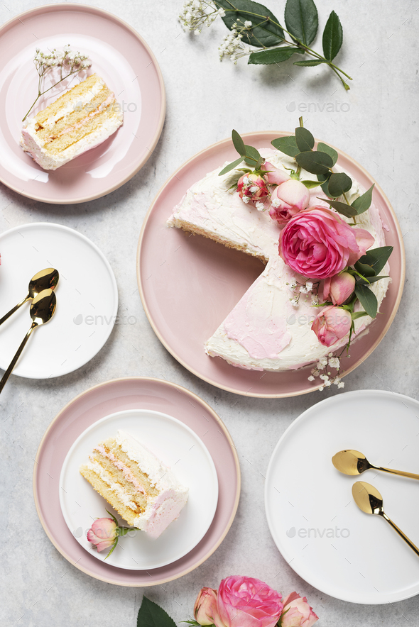 Birthday party concept with rose white cake decorated with pink roses, top down view image