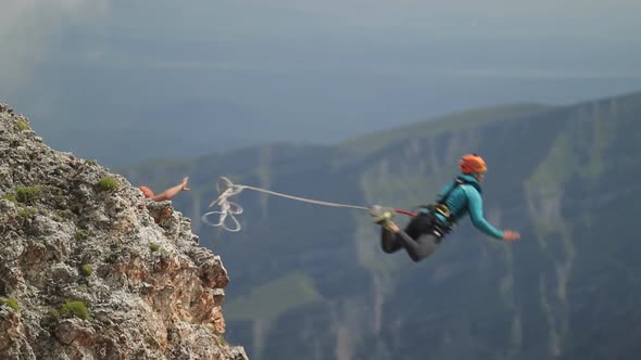 Man Jumping Off a Cliff, Rope Jumping in the Mountains
