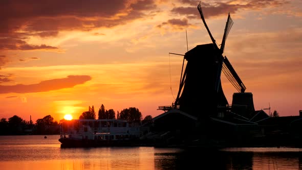 Windmills at Zaanse Schans in Holland on Sunset. Zaandam, Nether alt