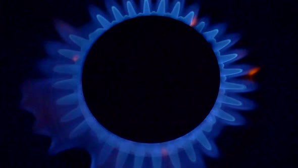 Gas-ring Stove with Blue Flame on Black Background. Slow Motion Shot alt