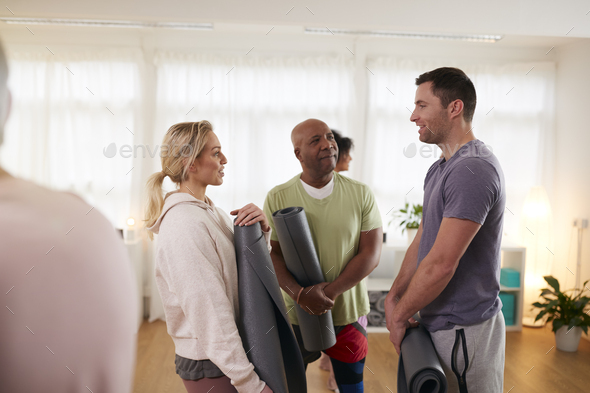 People In Exercise Clothing Meeting And Chatting Before Fitness Or Yoga Class In Community Center