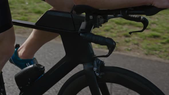 Selfimprovement an Hardy Triathlete Rides a Bike Pro Cyclist Rides on the Road Athlete Trains on a alt