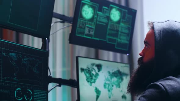 Side View of Bearded Cyber Terrorist Wearing a Hoodie alt