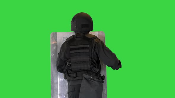 Riot Police Unit Making Sound Hitting Shield with Baton on a Green Screen Chroma Key alt