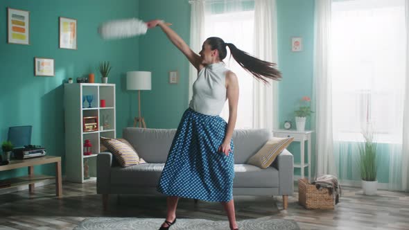 Young Woman Is Dancing with Cleaning Brush and Singing