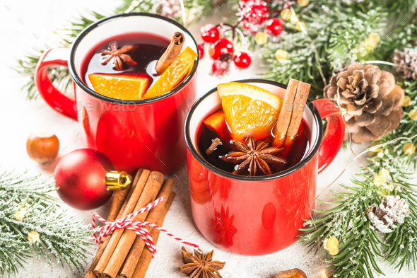 Mulled wine in red mugs with christmas decorations. Stock Photo by Nadianb
