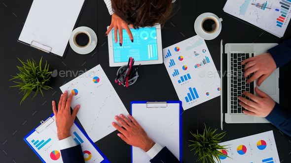 Business people having meeting analysing financial statistics - Stock Photo - Images