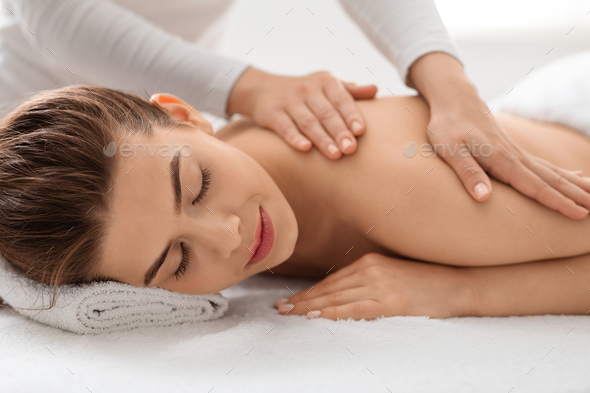 Young Beautiful Woman Getting Back Massage Stock Photo, Picture