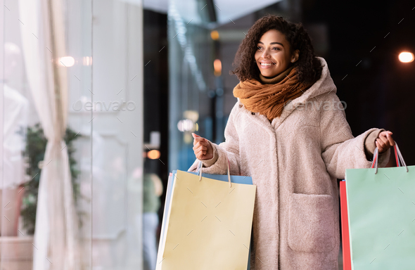 soil Percentage Host of Black woman with shopping bags looking at mall Stock Photo by  Prostock-studio
