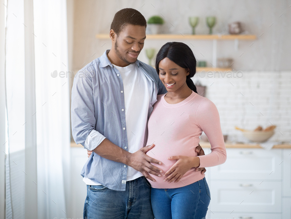 Happy Black Young Man Embracing His Lovely Pregnant Girlfriend And ...