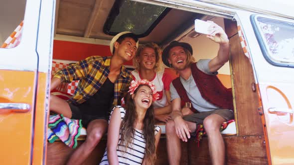Group of friends taking selfie with mobile phone alt