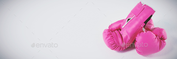 Pink boxing gloves on white background