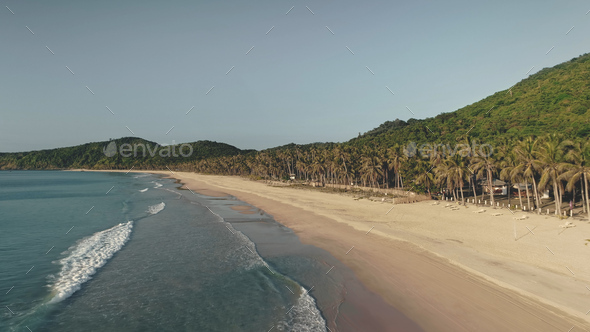 Waves at ocean coast aerial. Forest at paradise island. Nobody tropic nature seascape