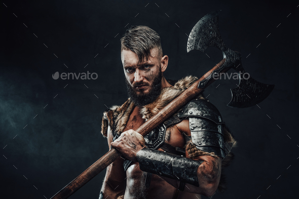 Medieval viking fighter holding huge axe on his shoulder Stock Photo by ...
