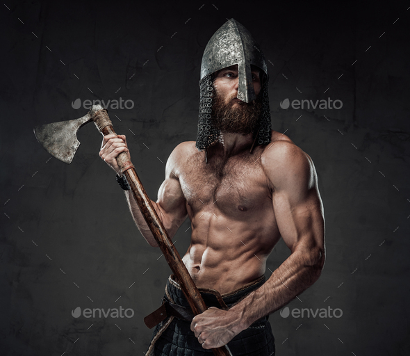 Nord warrior posing with his axe in dark background Stock Photo by fxquadro