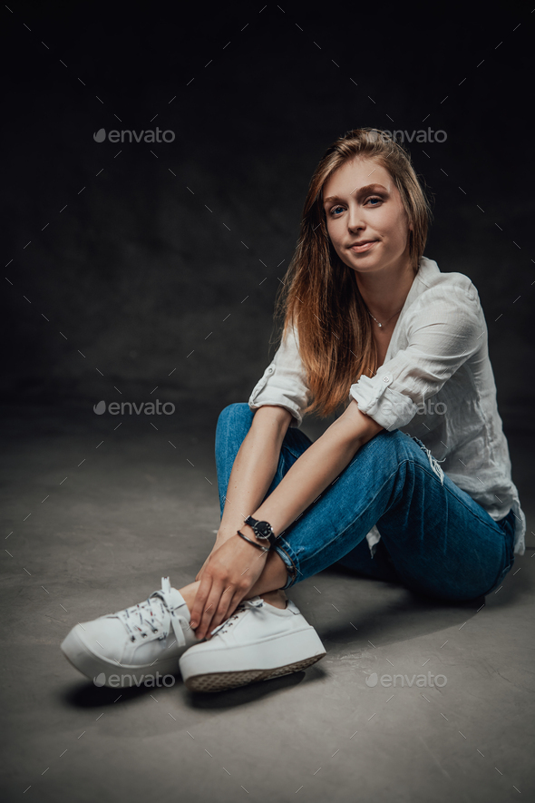 Pretty girl with long hairs in casual clothing in dark background Stock  Photo by fxquadro
