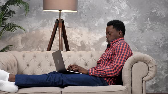 African American Businessman Works Laptop Online Chatting with Company Employees alt