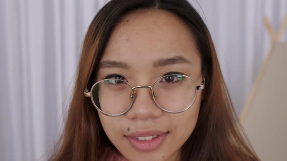 Close Up of Middle Eastern Young Woman Face in Glasses Girl Student Takes Pictures on a Retro Camera alt