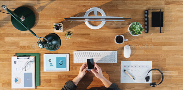 Businessman at the desk, office gadgets and supplies Stock Photo by  halfpoint