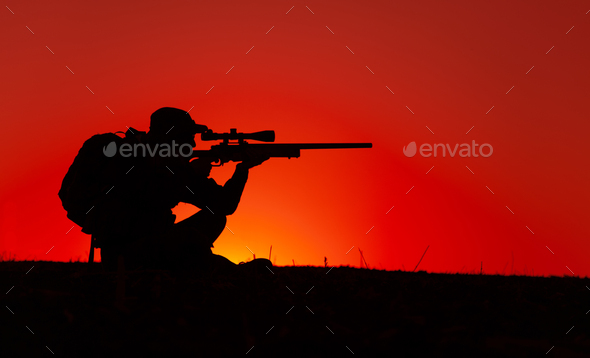 Commando sniper aiming, shooting rifle on seacoast - Stock Photo - Images