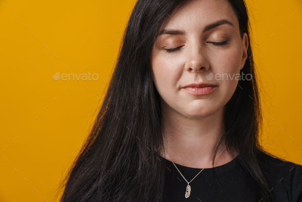 Close up of a young woman with eyes closed - Stock Photo - Images