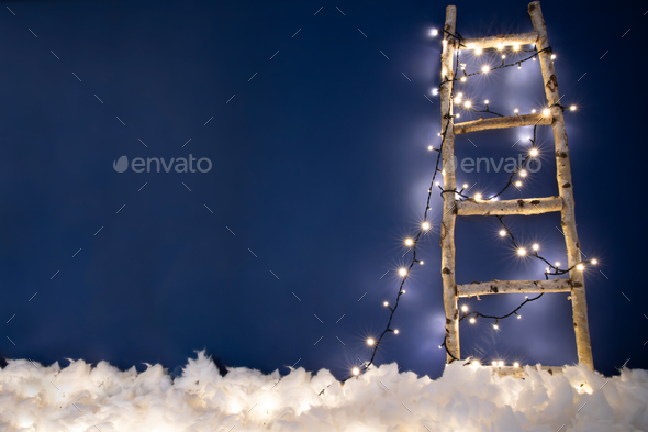 Christmas and holidays concept - ladder going up in blue sky - Stock Photo - Images