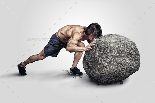 Muscular male pushing big stone.