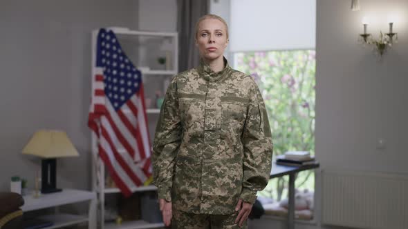 Medium Shot Portrait of Serious Confident Female Recruit Saluting in Slow Motion Looking at Camera alt