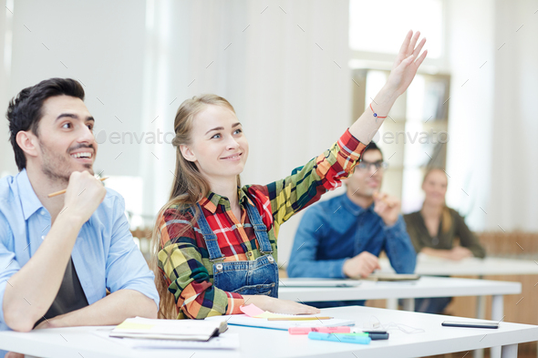 Raising hand to answer Stock Photo by Pressmaster | PhotoDune