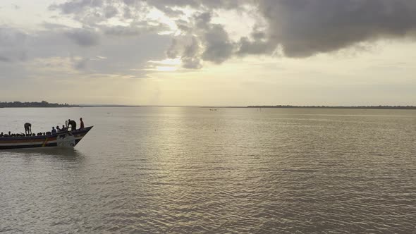 canoe or boat with people crossing river alt
