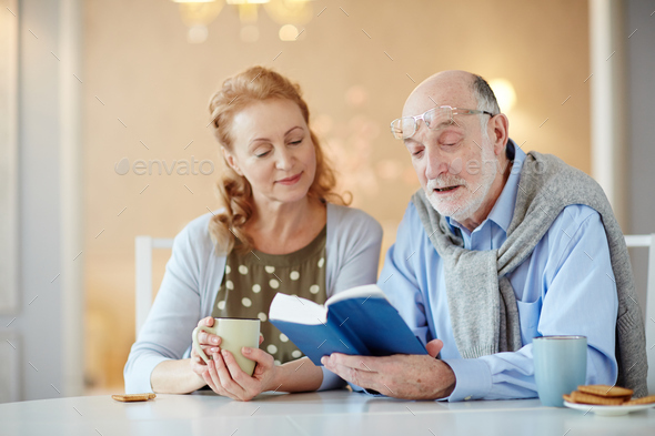 Reading to wife - Stock Photo - Images