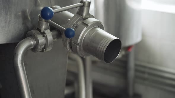 Drain pipe for finished cheese. Equipment for making cheese in the production room. Close-up alt