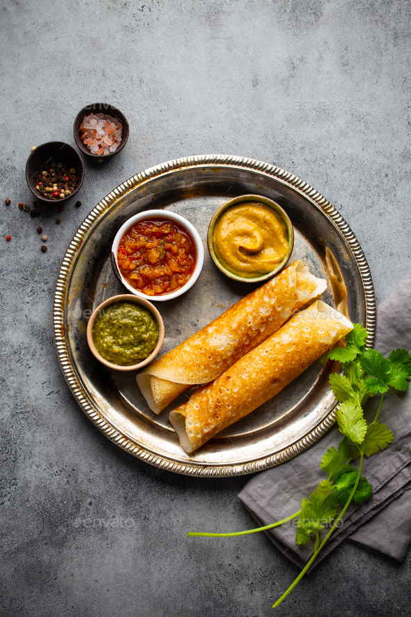 Traditional Indian rice pancakes Dosa with different dips chutney and